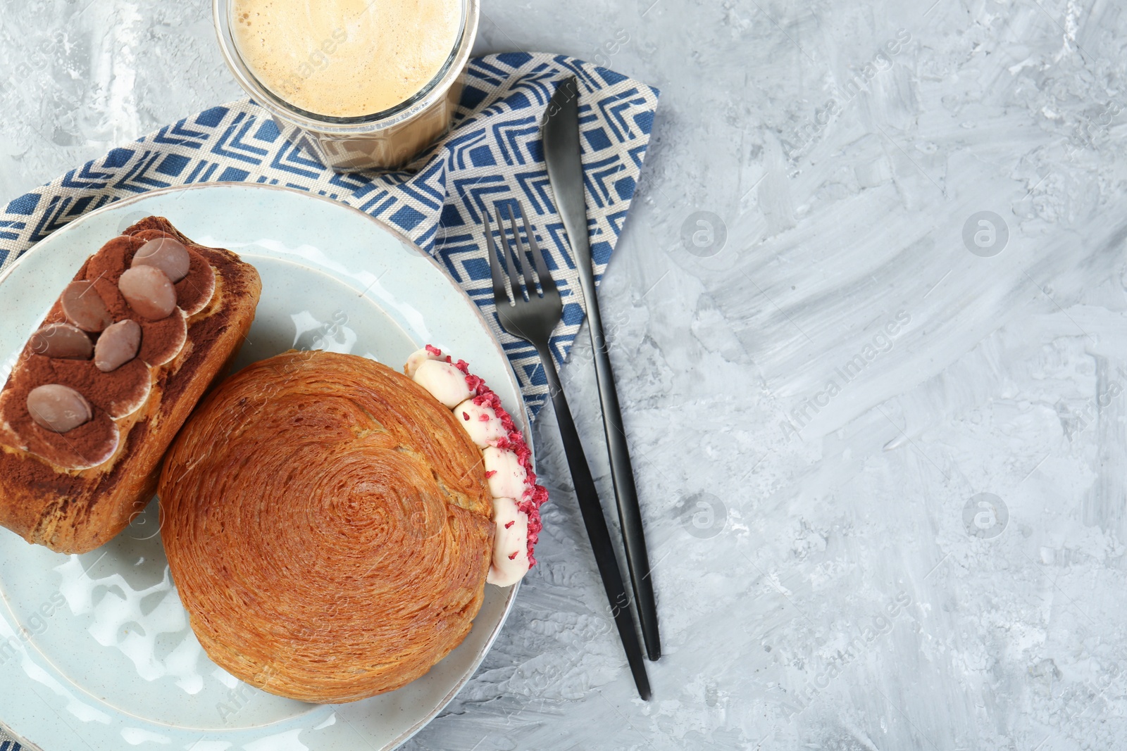 Photo of Tasty puff pastry. Round croissants served with coffee on light textured table, flat lay. Space for text