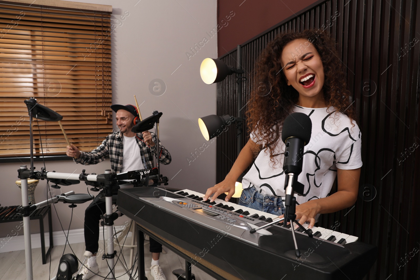 Photo of Music band performing in modern recording studio