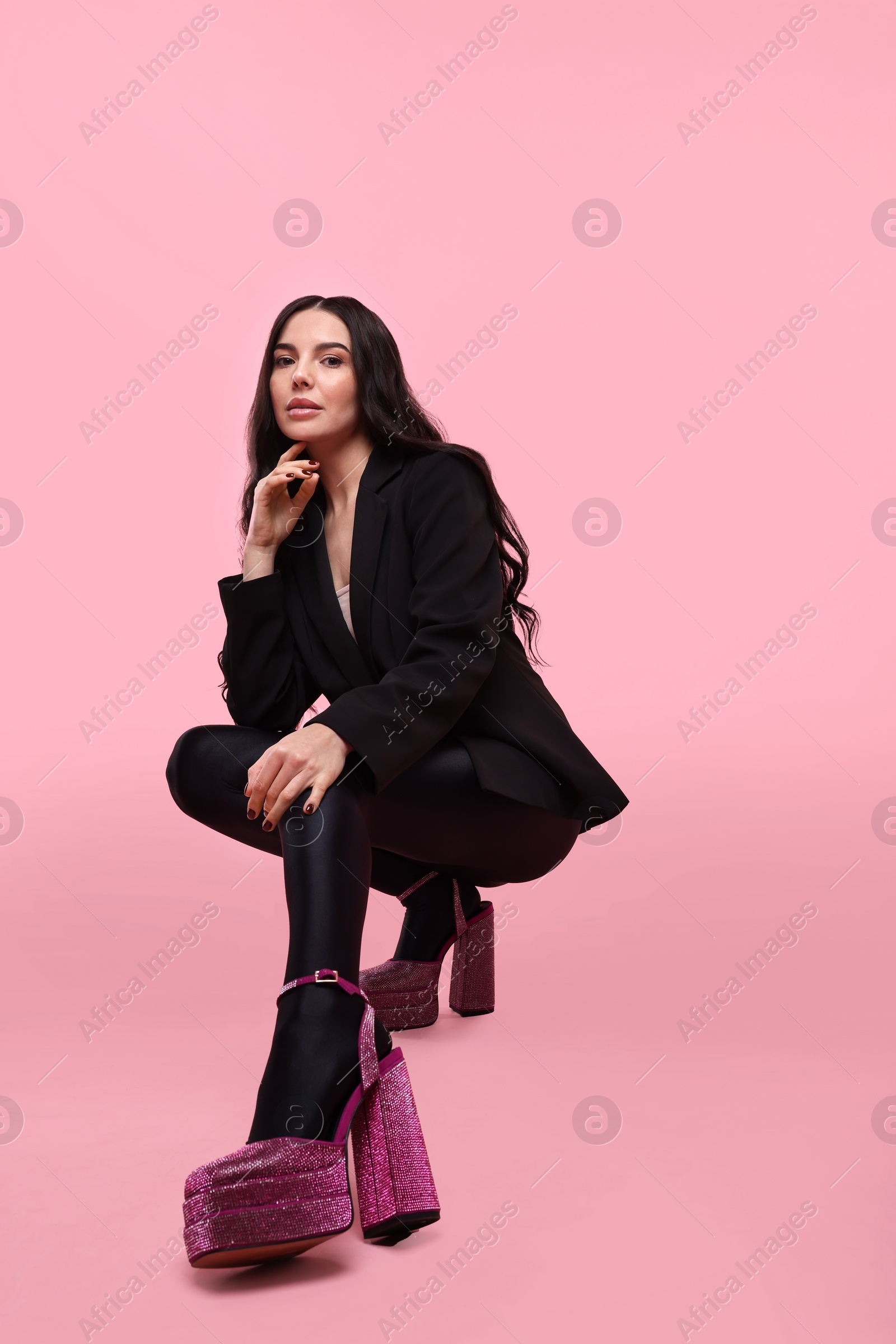 Photo of Stylish woman in black jacket on pink background