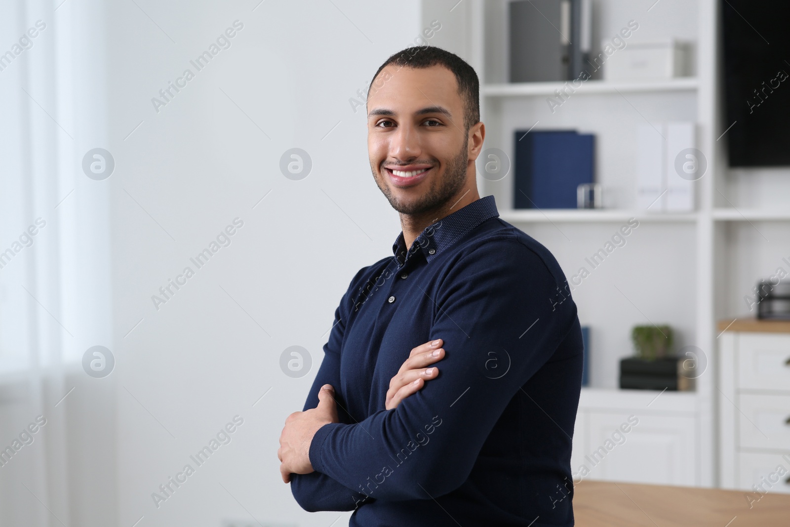 Photo of Smiling young businessman in his modern office