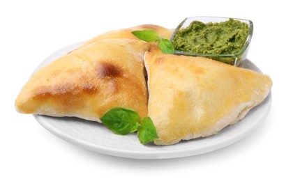 Photo of Delicious samosas with basil and pesto sauce isolated on white