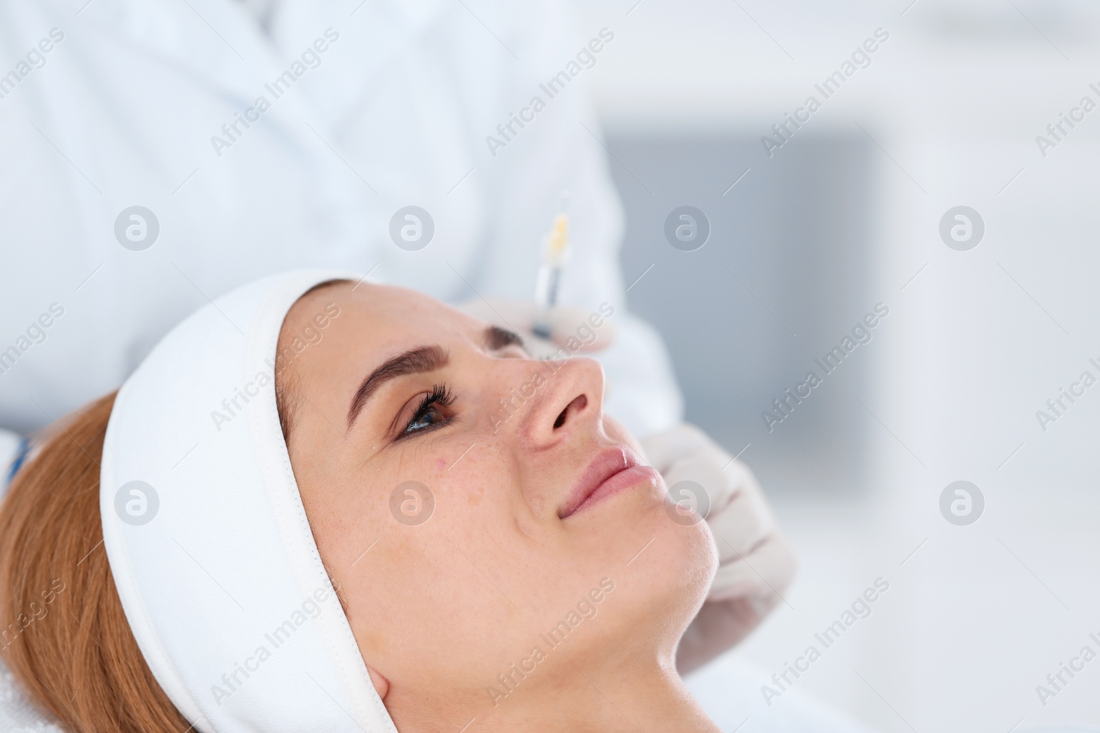 Photo of Woman undergoing face biorevitalization procedure in salon, closeup. Cosmetic treatment