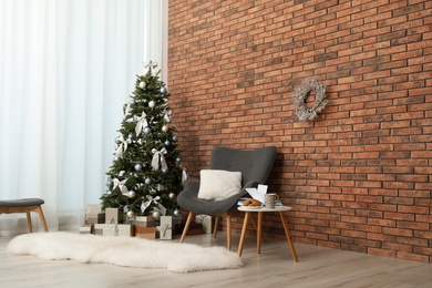 Stylish living room interior with decorated Christmas tree