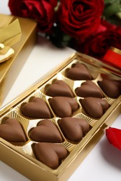 Photo of Tasty heart shaped chocolate candies on white background. Valentine's day celebration