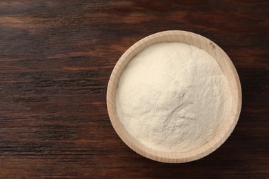 Bowl of agar-agar powder on wooden table, top view. Space for text