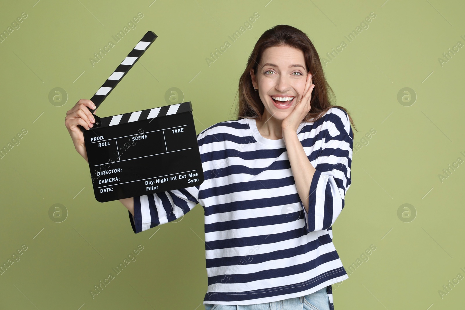 Photo of Making movie. Smiling woman with clapperboard on green background