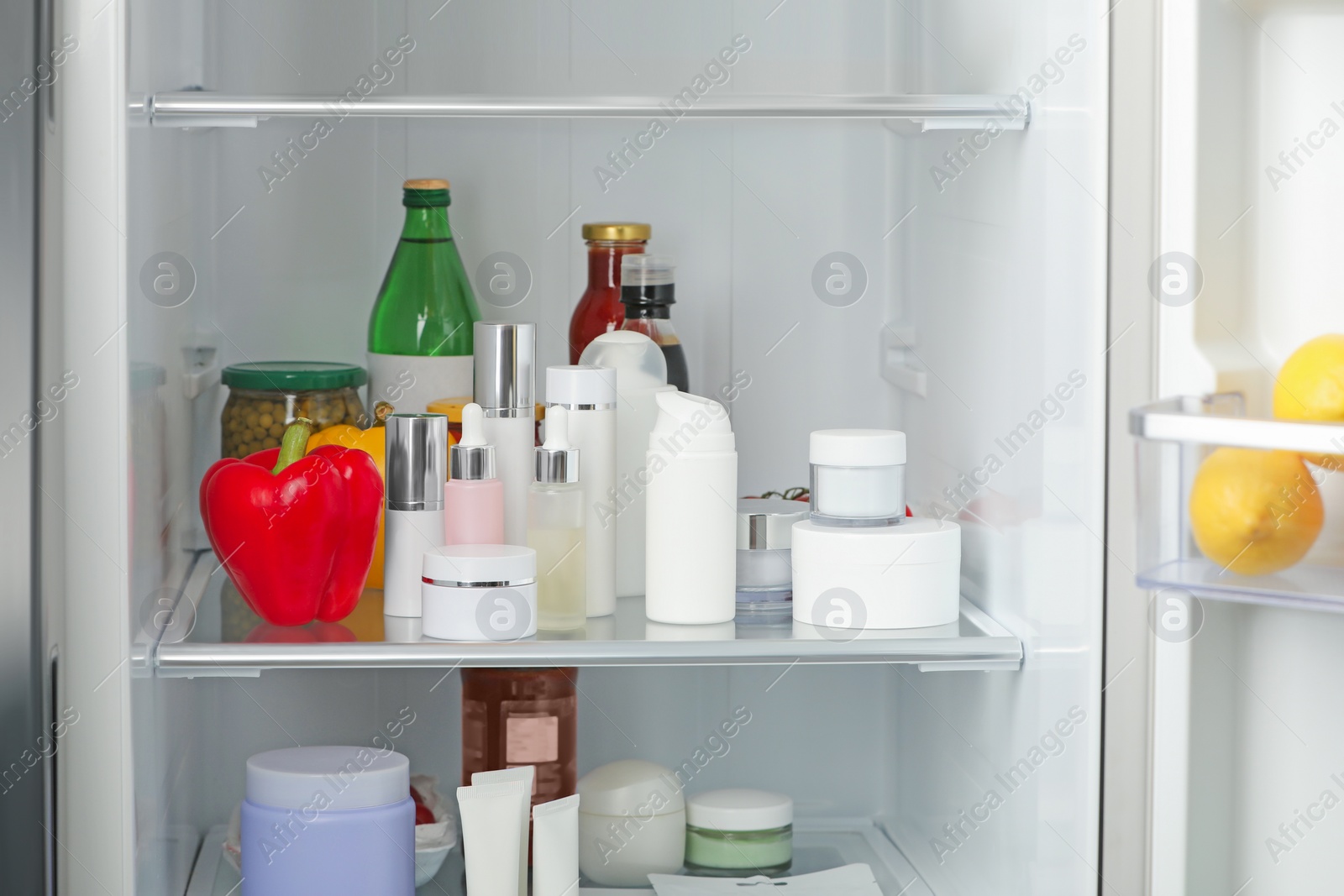 Photo of Different cosmetic products on shelves in refrigerator