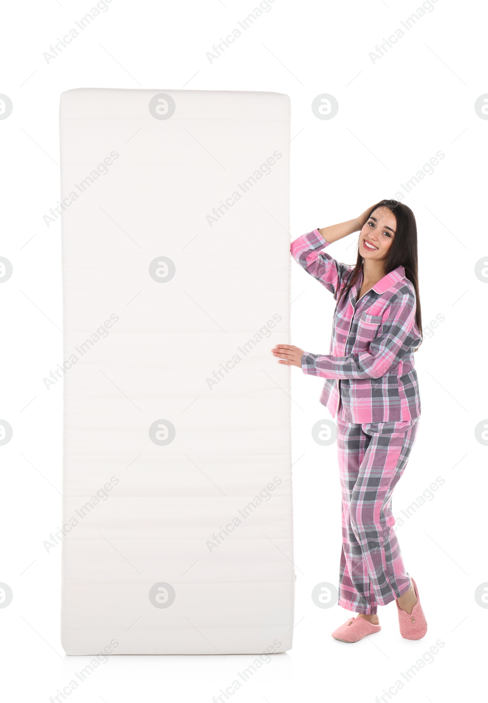 Photo of Young woman with comfortable mattress isolated on white