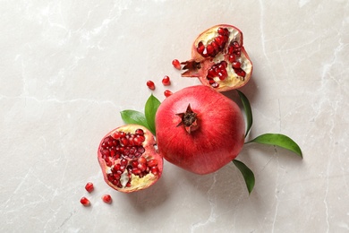 Photo of Flat lay composition with ripe pomegranates on light background