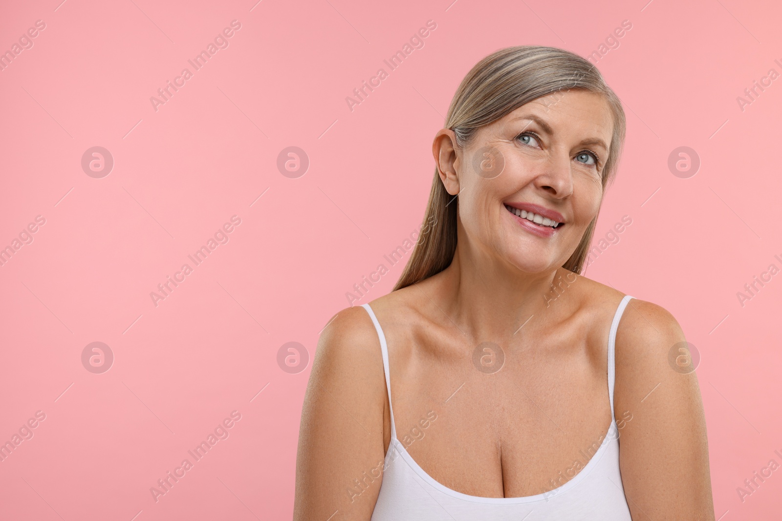 Photo of Beautiful woman with healthy skin on pink background, space for text