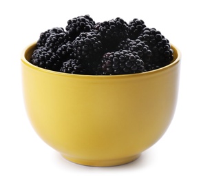 Yellow bowl of tasty ripe blackberries on white background