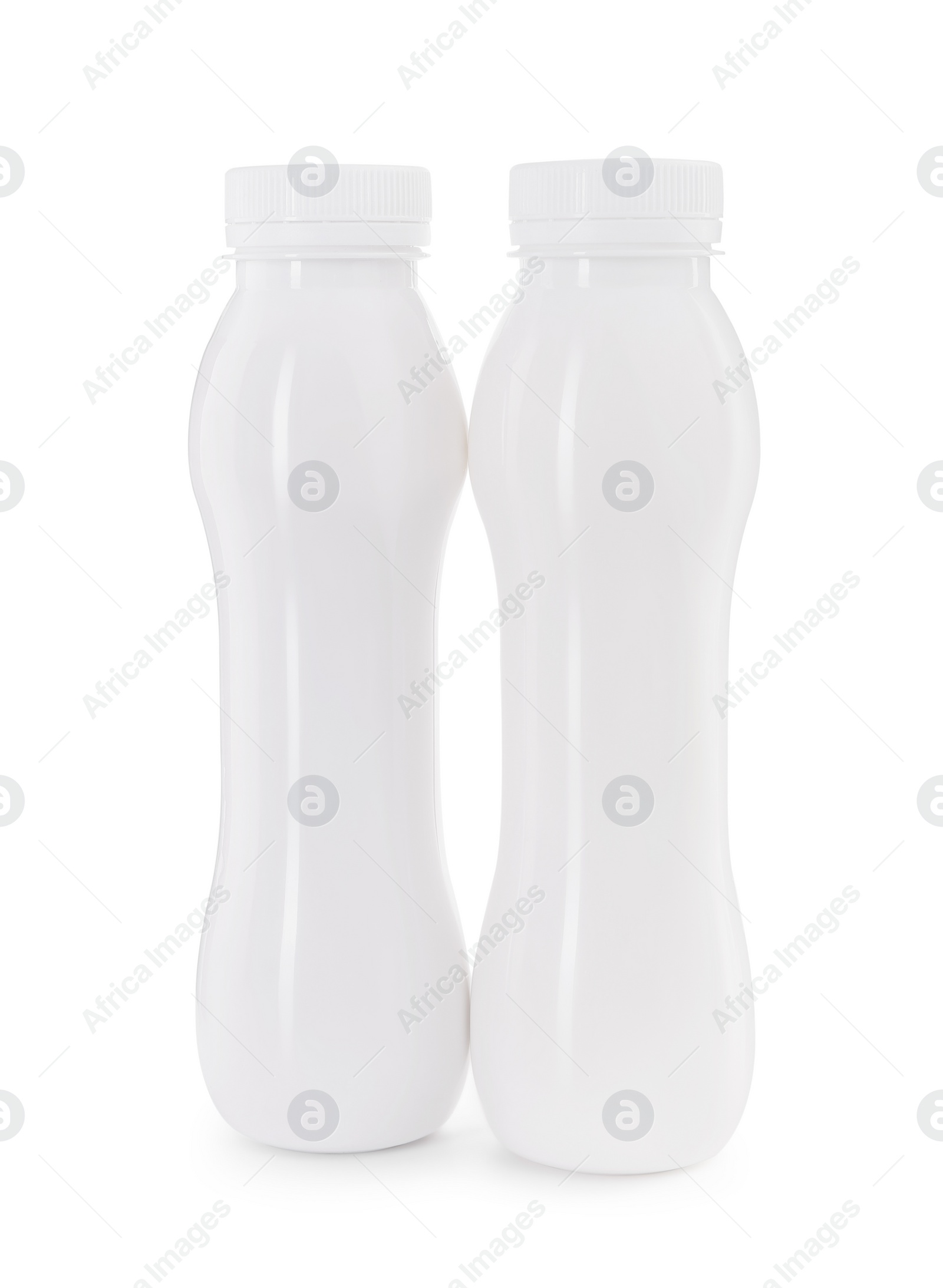 Photo of Tasty yogurt in bottles isolated on white