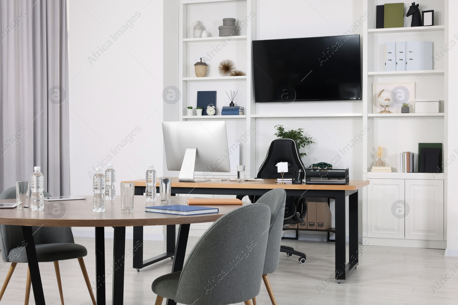 Photo of Stylish office with comfortable furniture and tv zone. Interior design