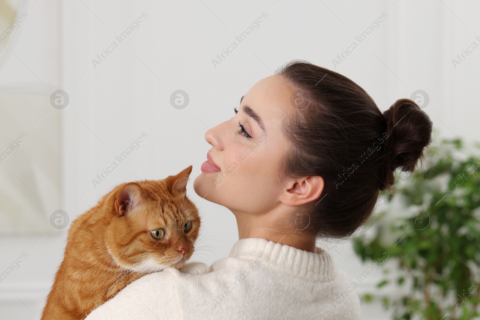 Photo of Beautiful woman with cute cat at home