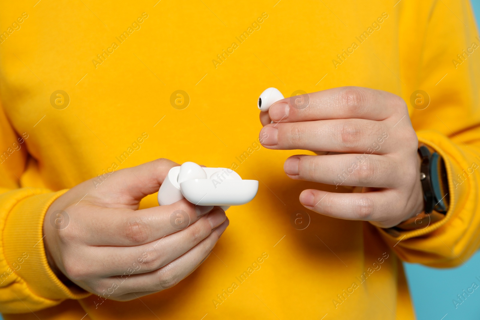 Photo of Man taking out earphones from case, closeup