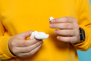 Man taking out earphones from case, closeup