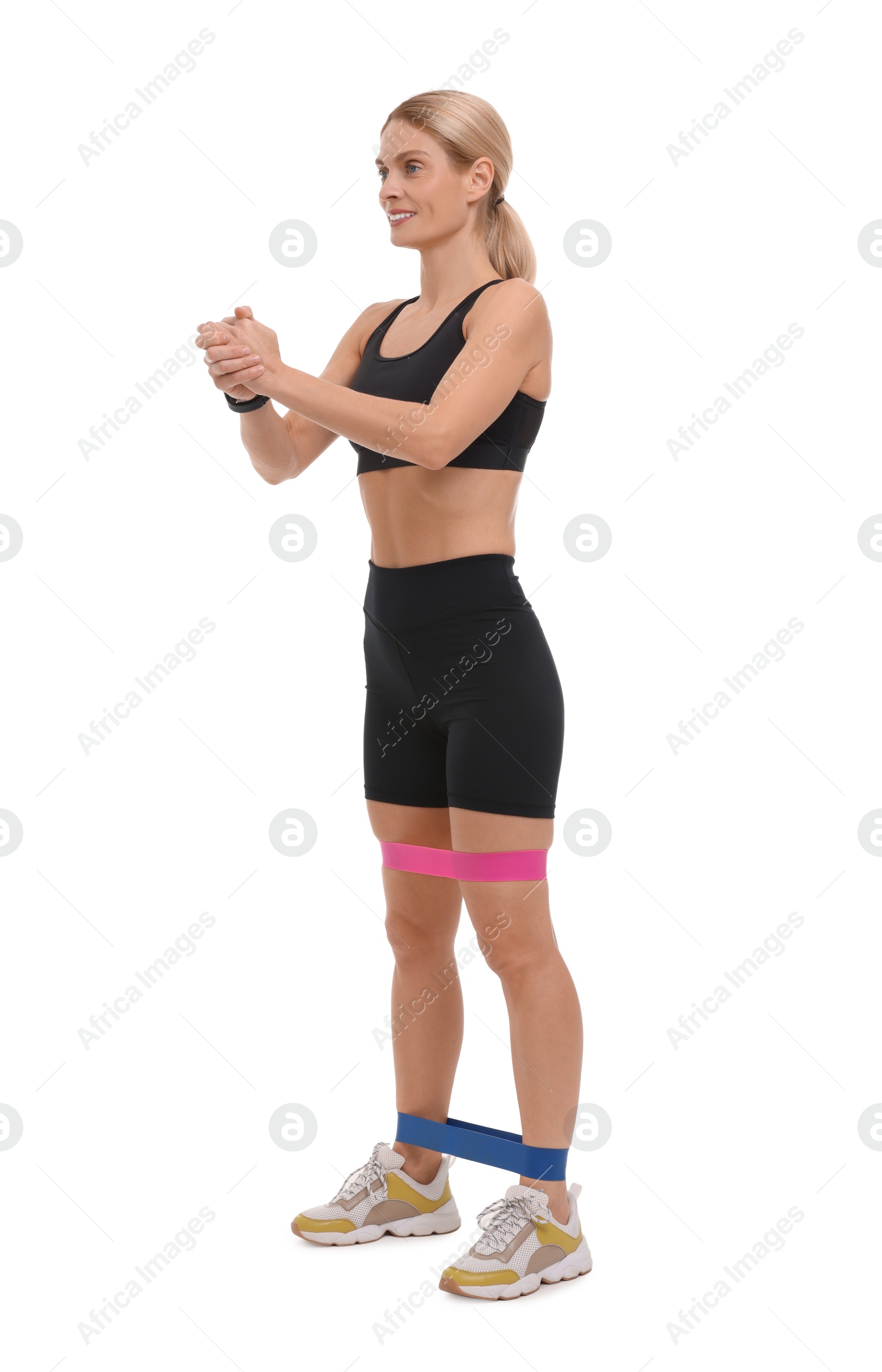 Photo of Woman exercising with elastic resistance band on white background