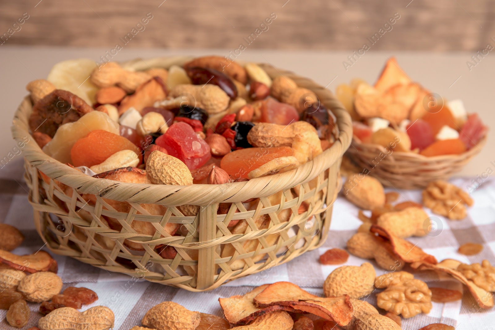 Photo of Mixed dried fruits and nuts on checkered tablecloth