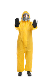 Photo of Woman in chemical protective suit making stop gesture on white background. Virus research