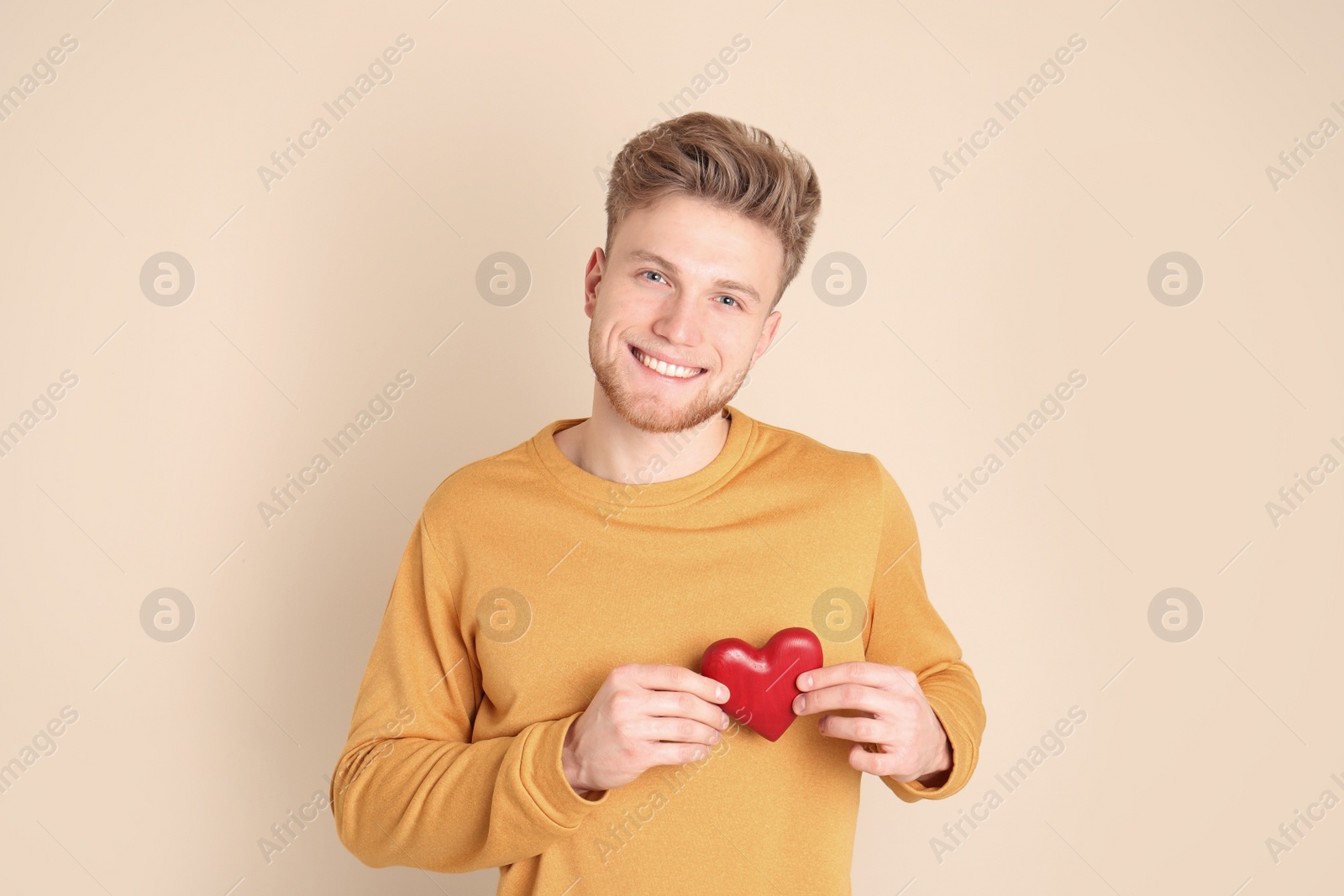 Photo of Portrait of young man with decorative heart on color background