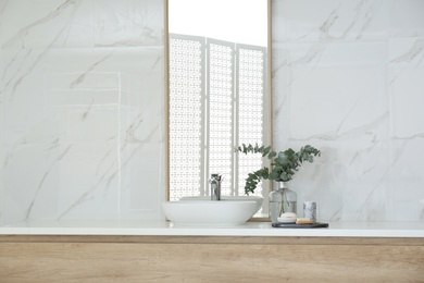 Modern bathroom interior with large mirror and vessel sink