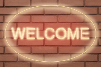 Stylish neon sign WELCOME on brick wall