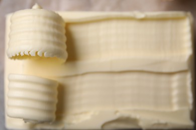 Tasty butter and curls on table, top view