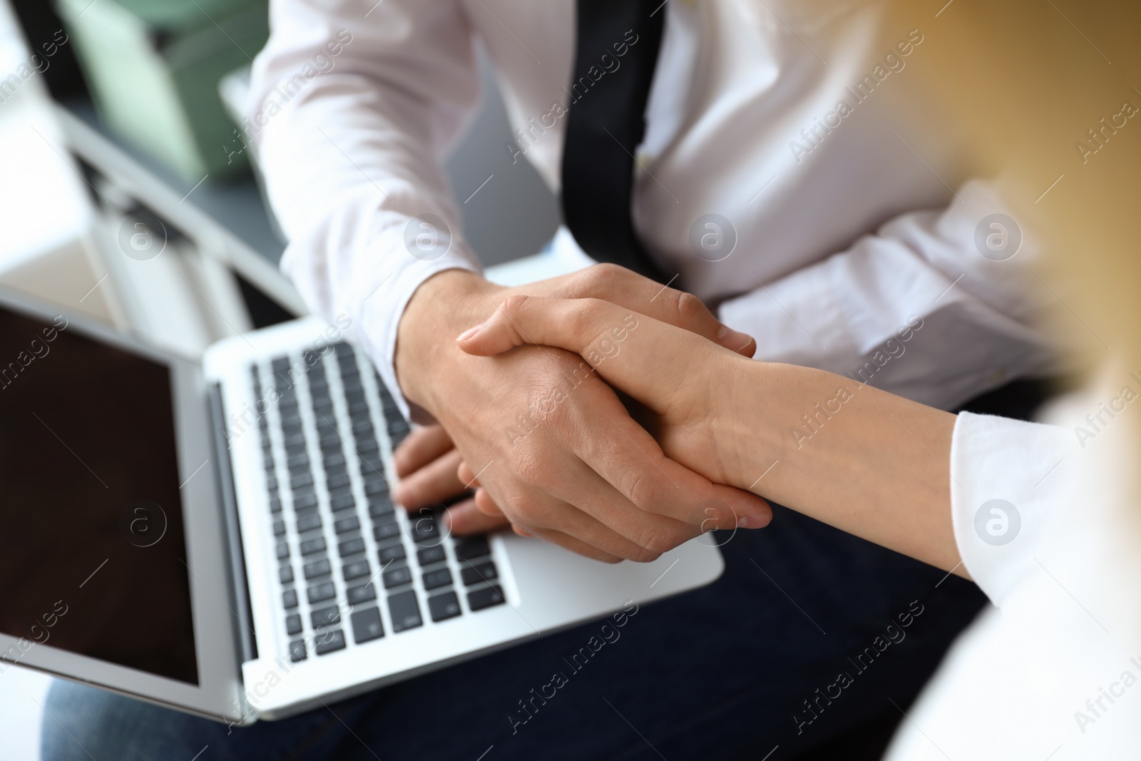 Photo of Business partners shaking hands after meeting, closeup