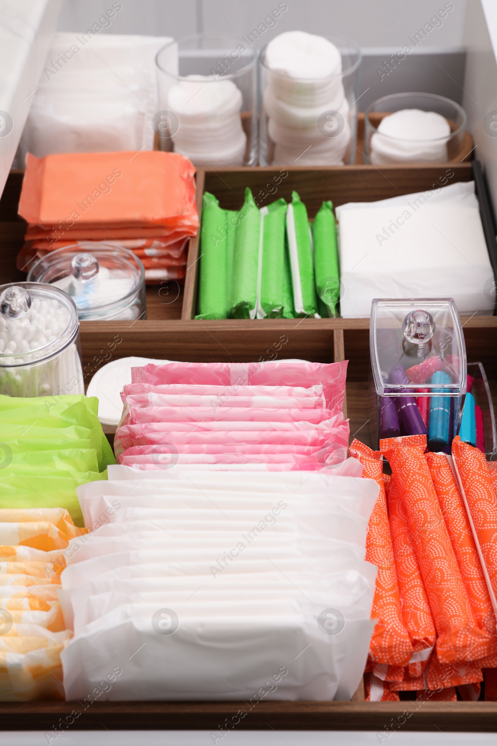 Photo of Storage of different feminine hygiene products in drawer, closeup