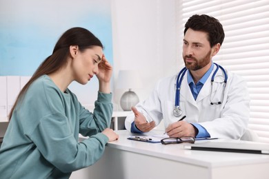 Photo of Doctor consulting patient during appointment in clinic