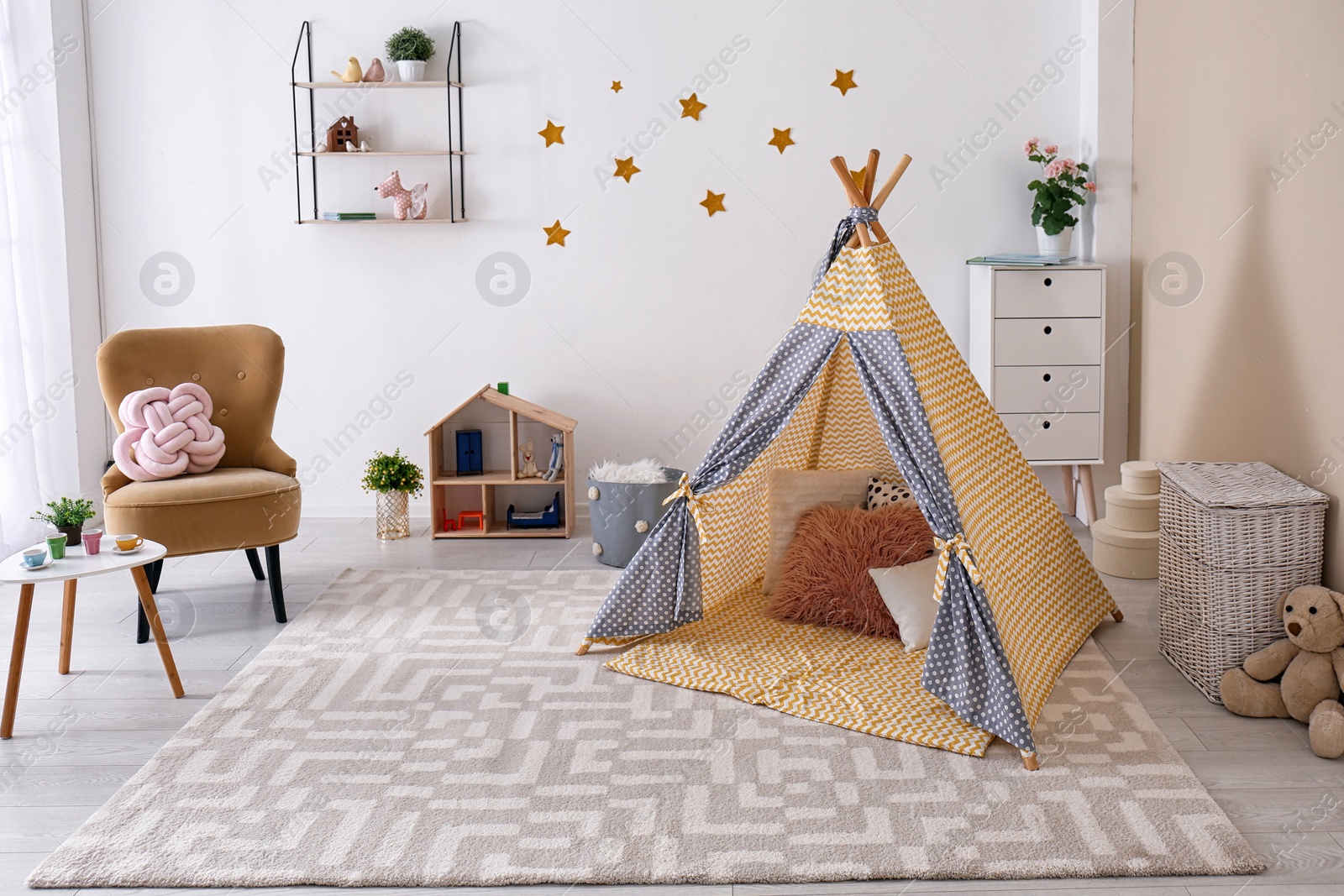 Photo of Cozy kids room interior with play tent and toys