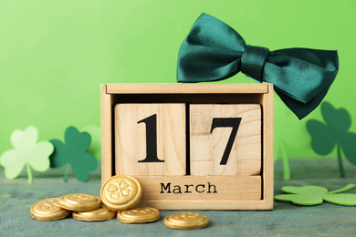 Photo of Composition with block calendar on wooden table. St. Patrick's Day celebration