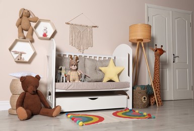 Photo of Cozy room with stylish furniture and toys for baby. Interior design