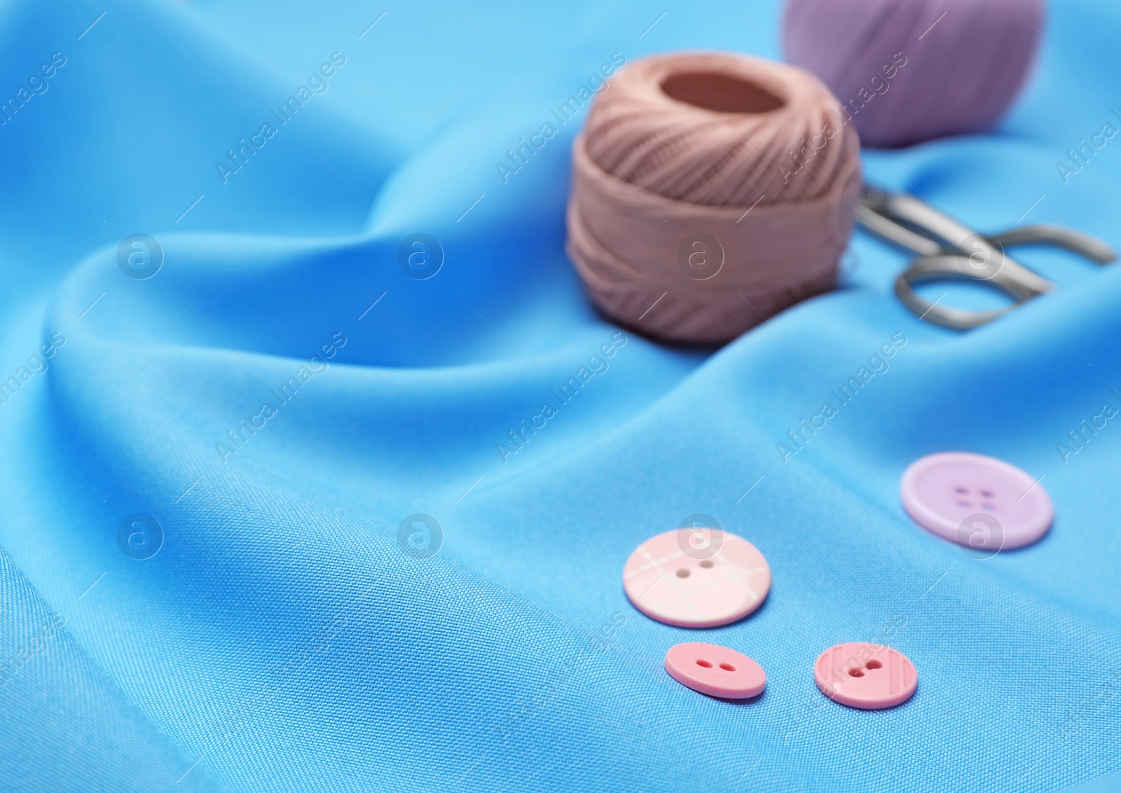 Photo of Composition with threads and sewing accessories on fabric
