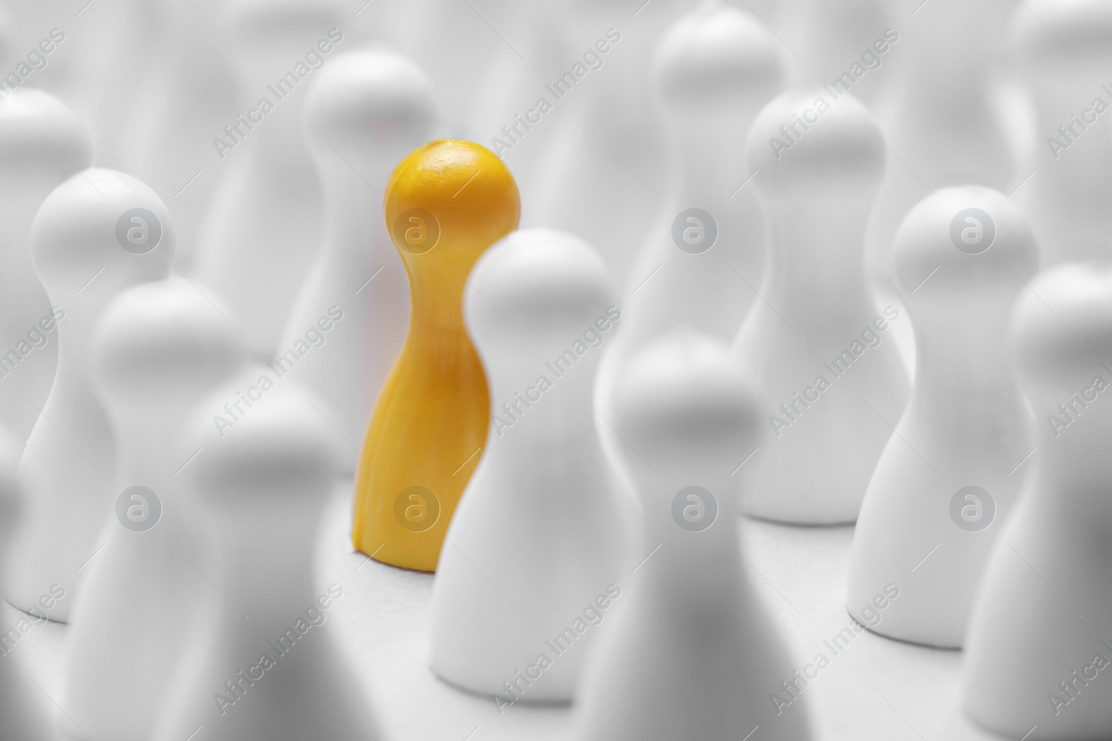 Photo of Yellow pawn among others on white background, closeup. Recruiter searching employee