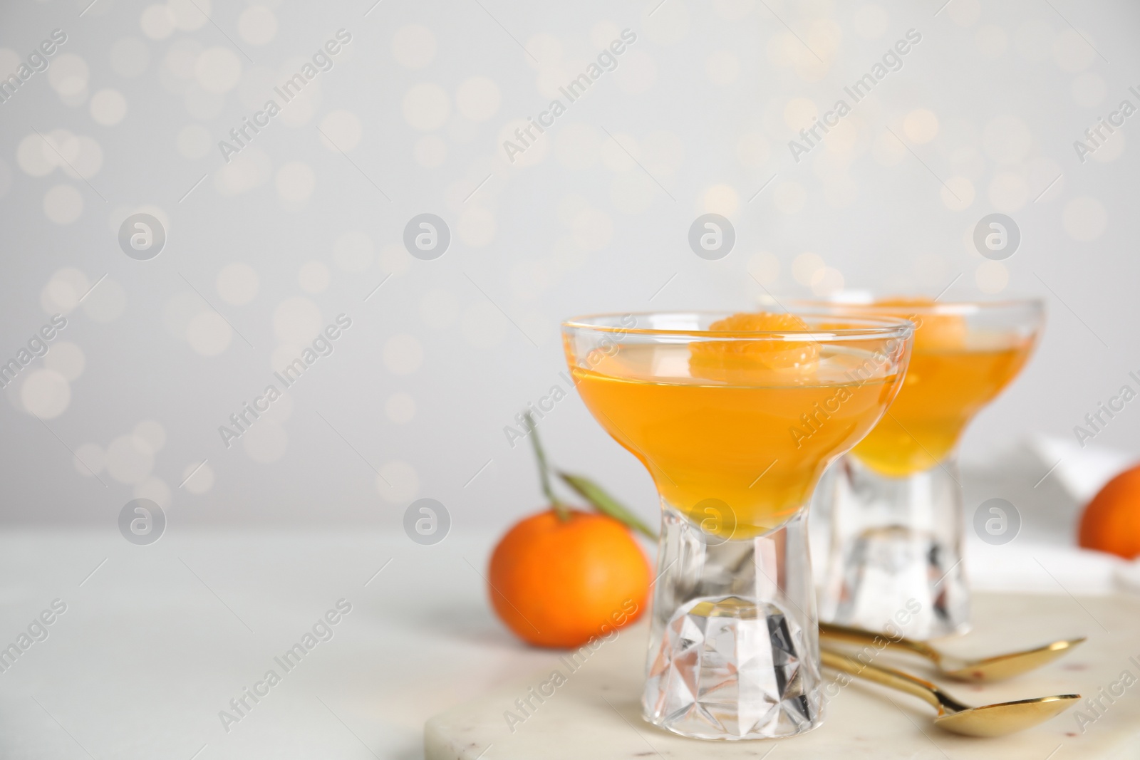 Photo of Delicious tangerine jelly on white table. Space for text