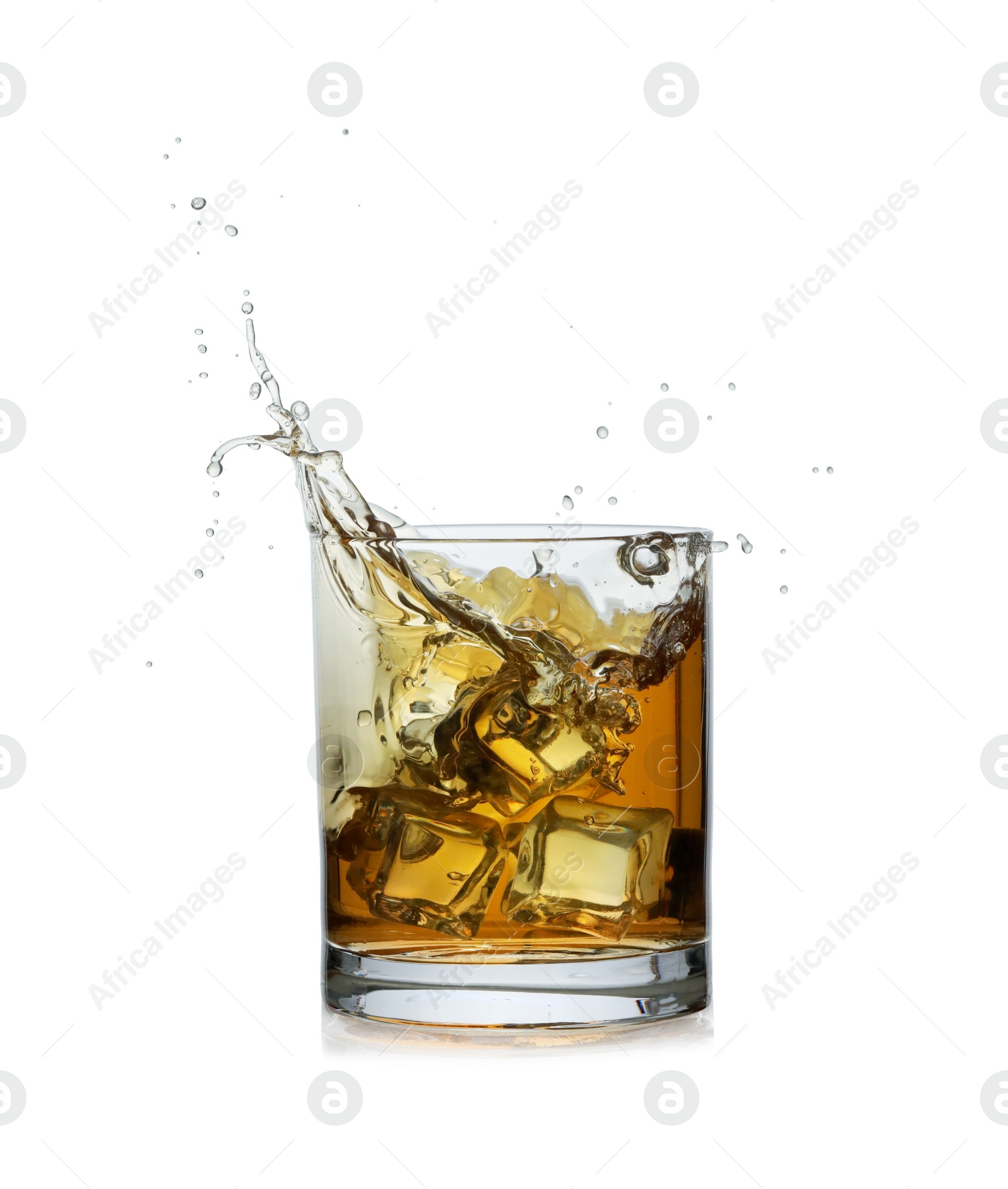 Photo of Whiskey splashing out of glass on white background