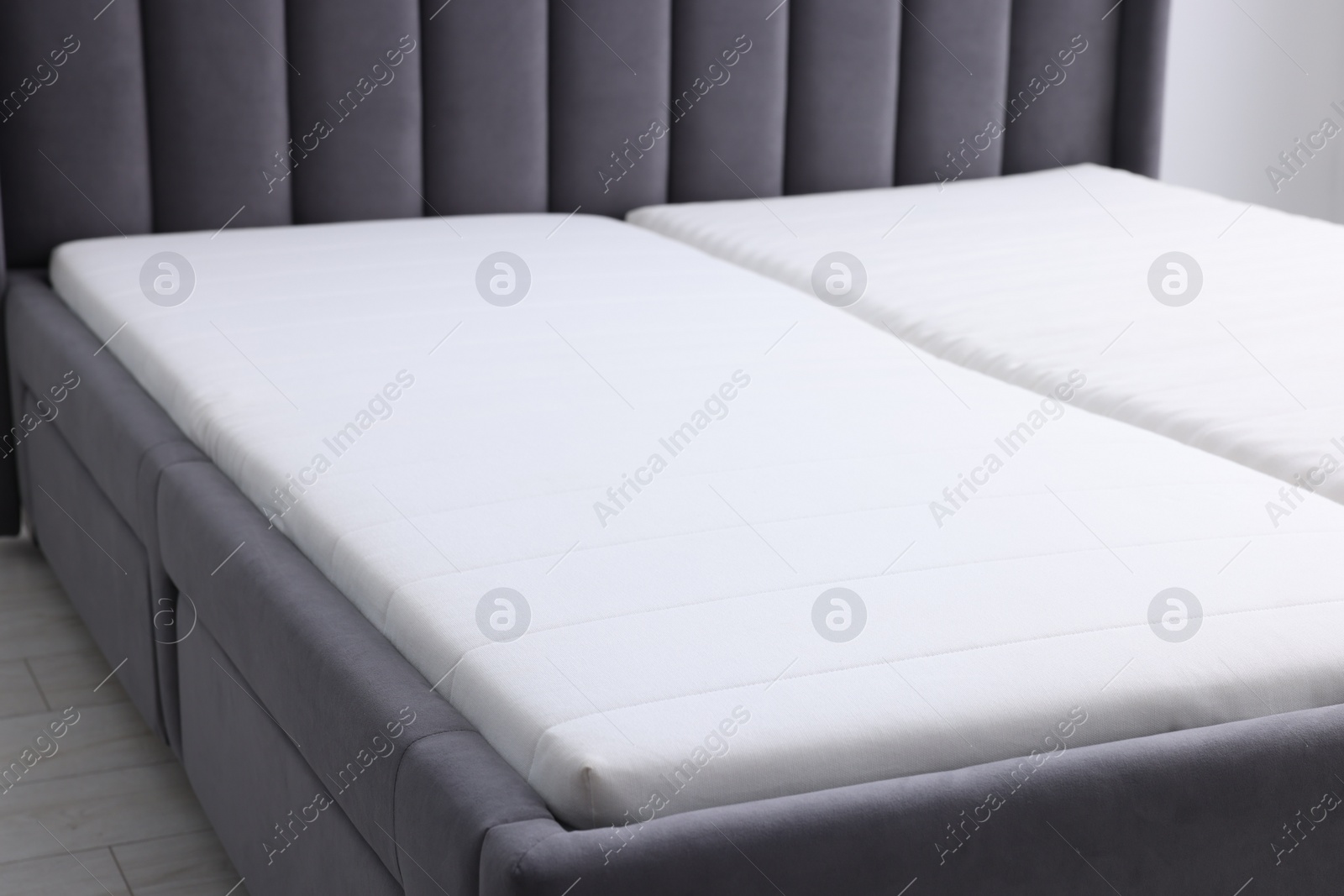 Photo of Comfortable bed with new soft mattress indoors