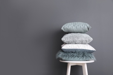 Photo of Chair with many different pillows and space for text on color background