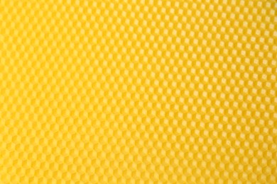 Photo of Natural beeswax sheet as background, top view