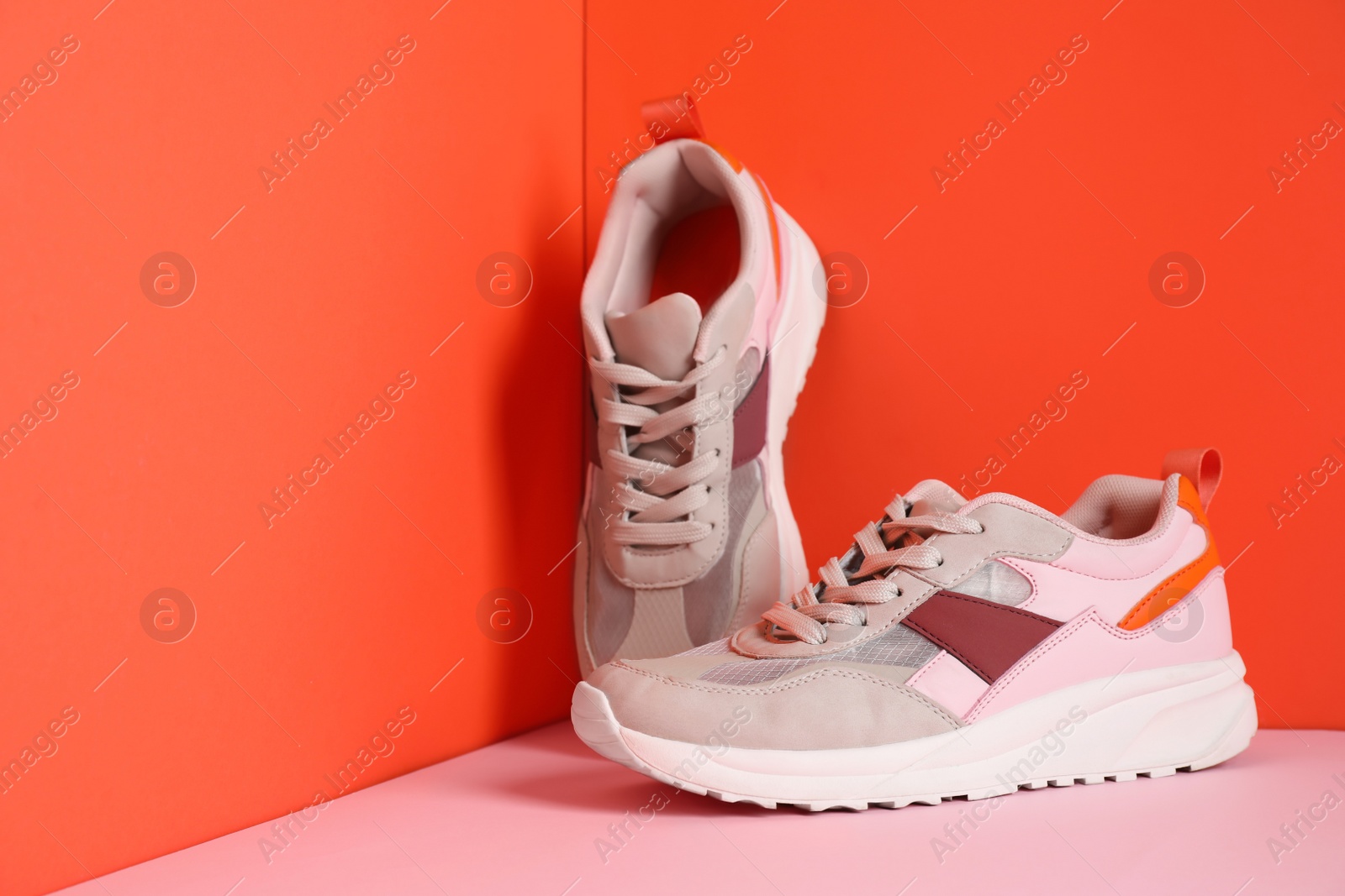 Photo of Stylish sports shoes on color background, space for text