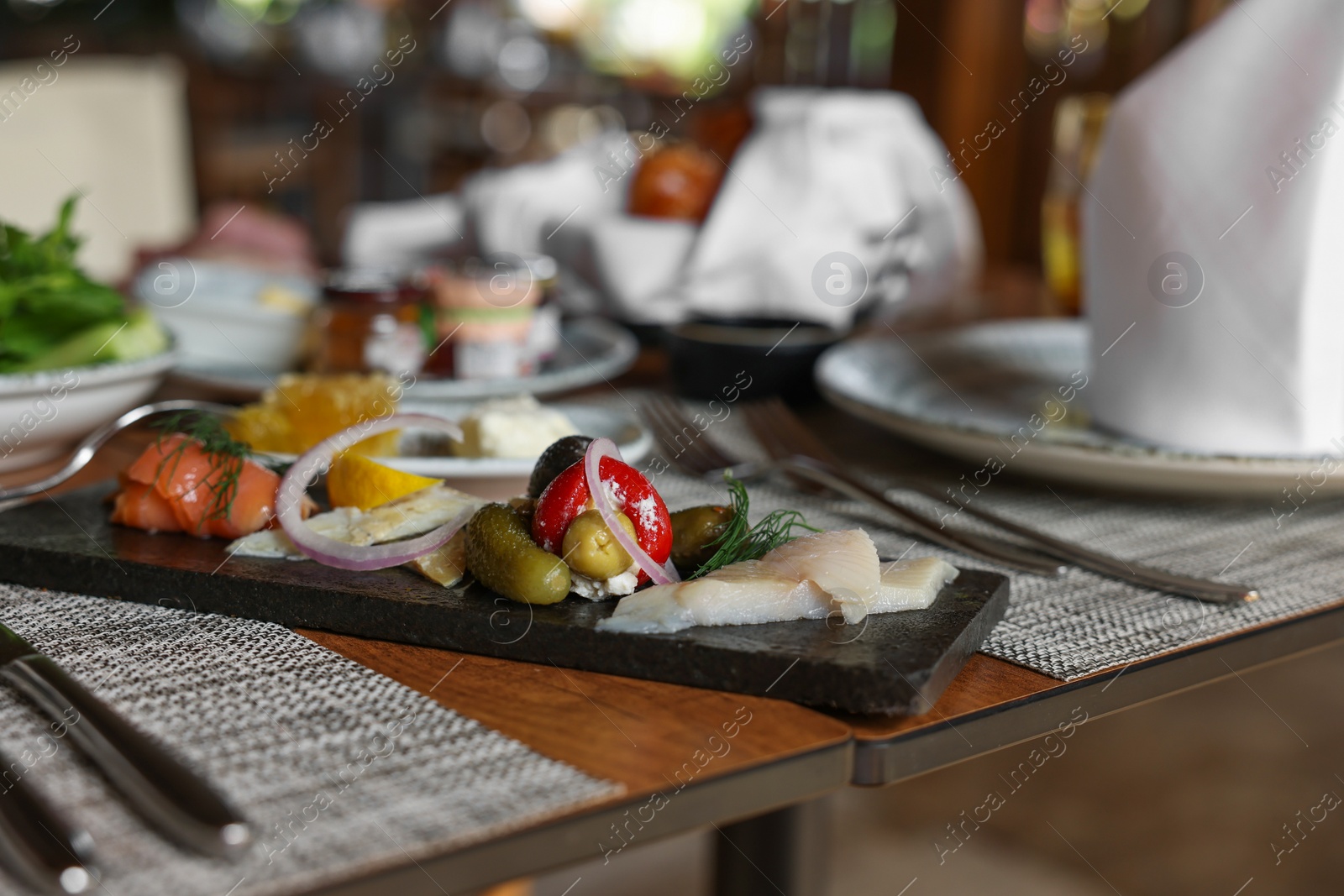 Photo of Tasty appetizers served on table in cafe, closeup