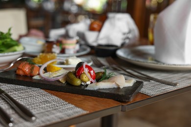 Tasty appetizers served on table in cafe, closeup