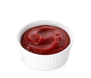 Photo of Tasty ketchup in bowl isolated on white, closeup