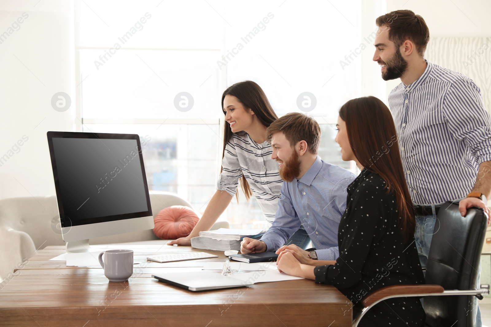 Photo of Group of colleagues using video chat on computer in office. Space for text