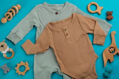 Photo of Flat lay composition with baby clothes and accessories on light blue background