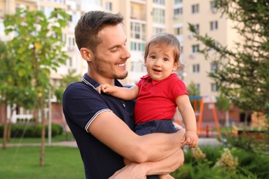 Father with adorable little baby outdoors. Happy family