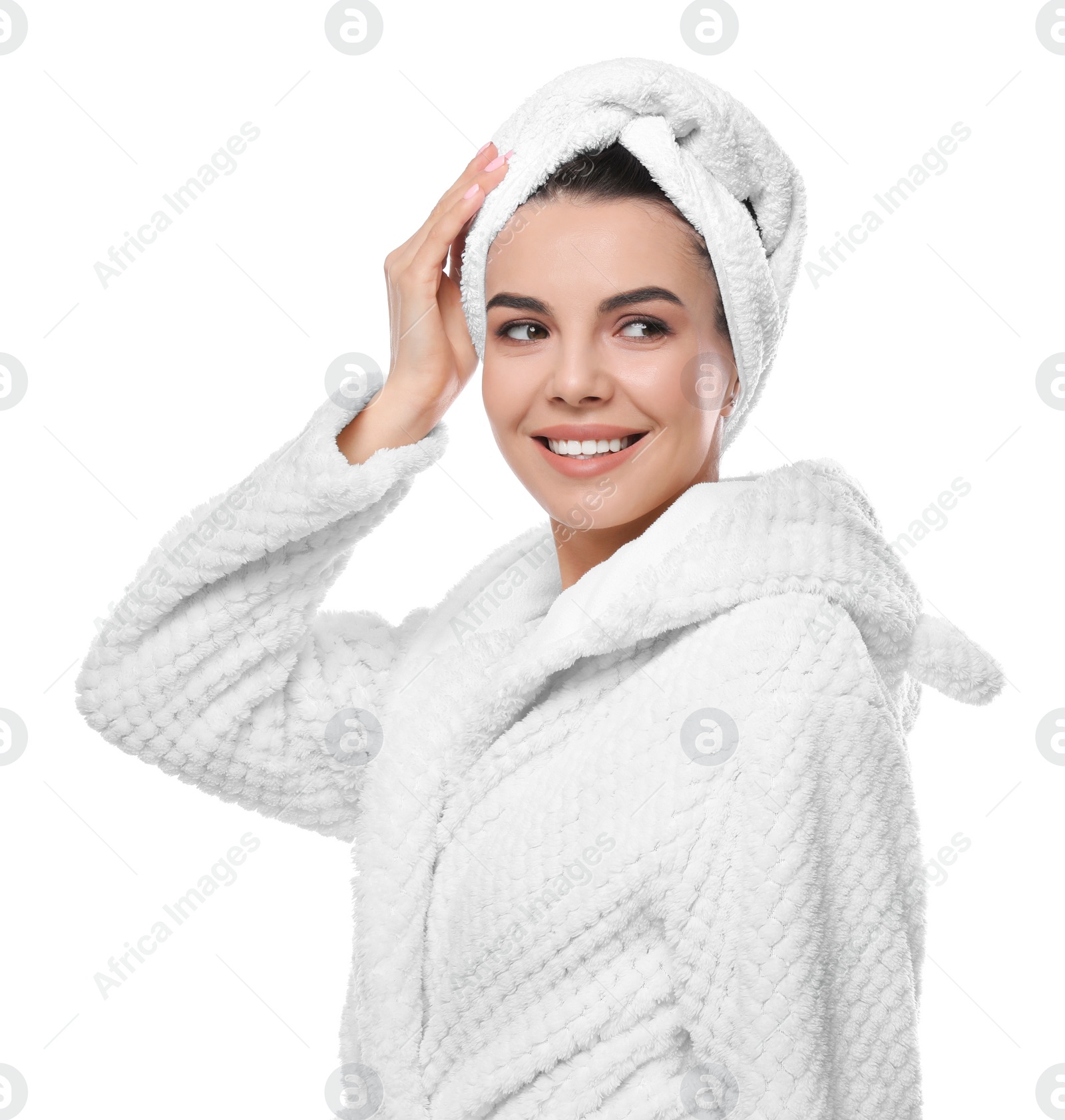 Photo of Happy young woman in bathrobe with towel on head against white background. Washing hair