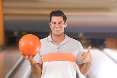 Man with ball in modern bowling club