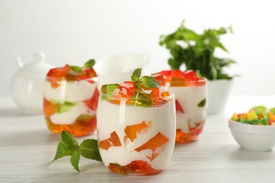 Delicious broken glass jelly dessert on white wooden table